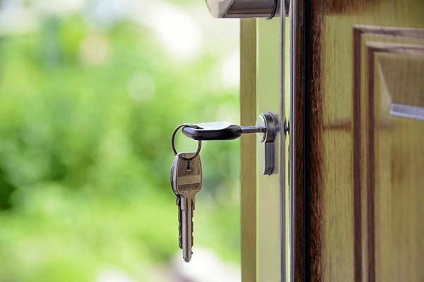 House key left in the deadbolt of an open front door