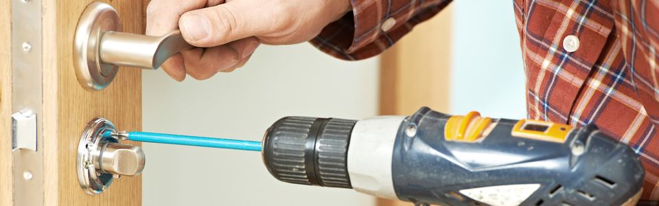 Drill removing the cylinder from a doorknob during a lock change